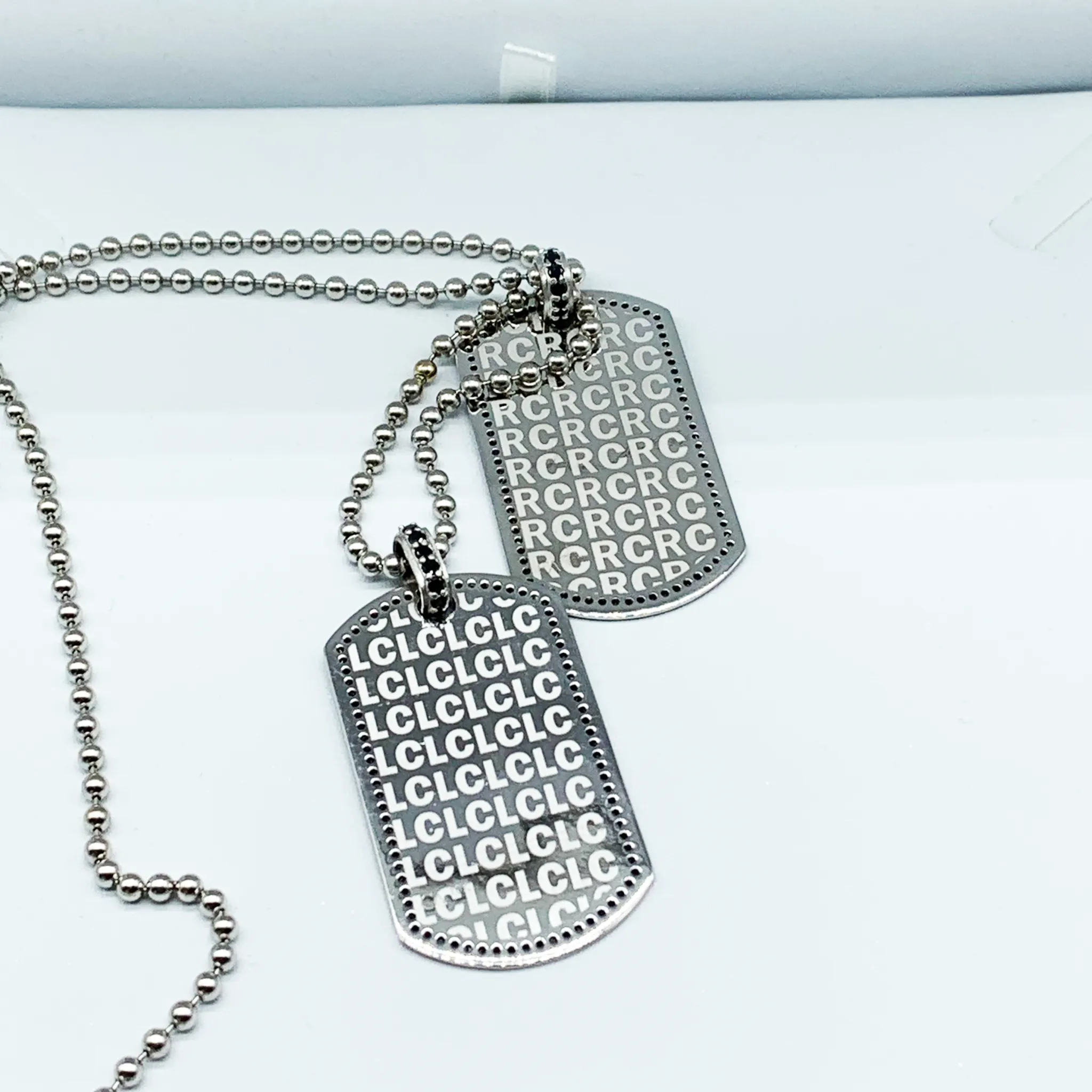 CA Custom “We are family” 18 karat white gold and black diamond dual tags.