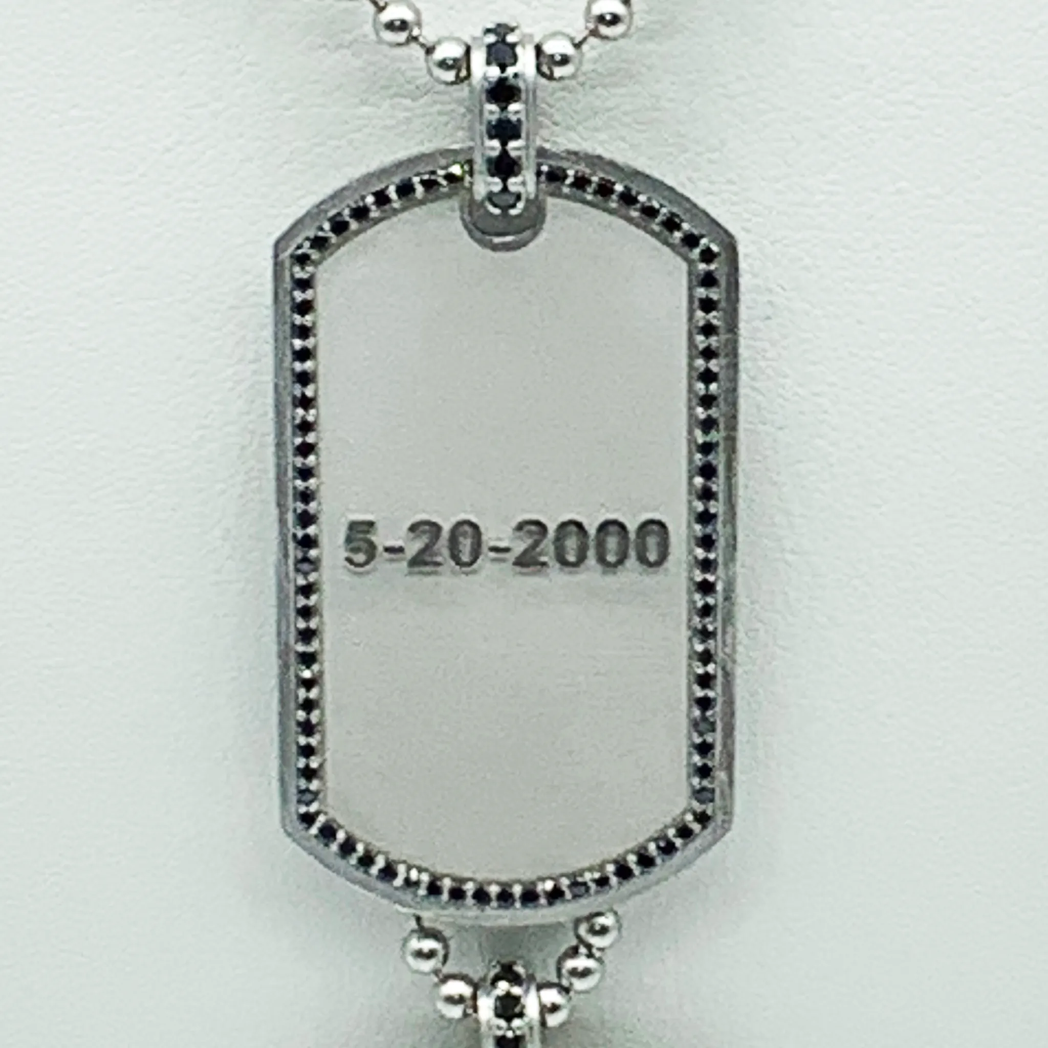 CA Custom “We are family” 18 karat white gold and black diamond dual tags.
